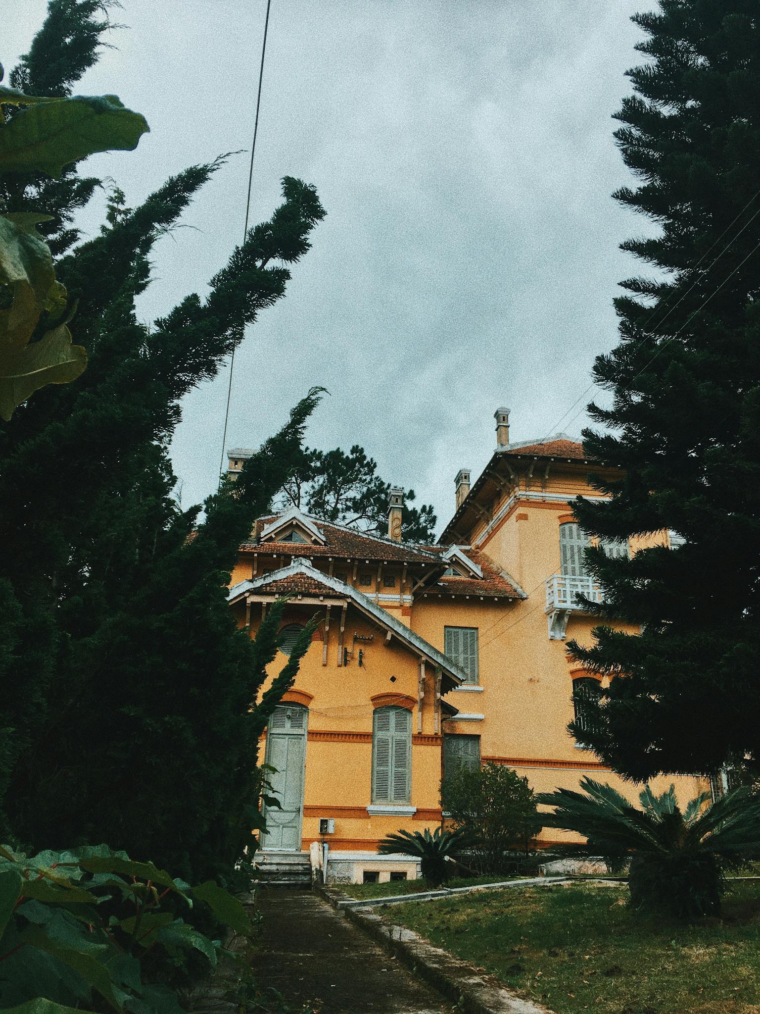 Beige Painted House Near Green Trees